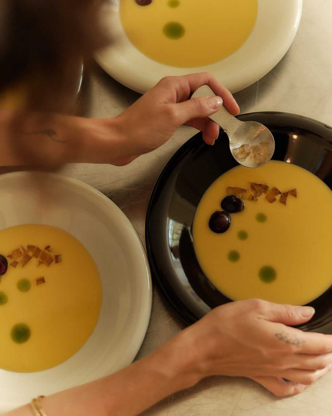 Chilled Corn Soup with calendula jelly, tarragon oil and cherries